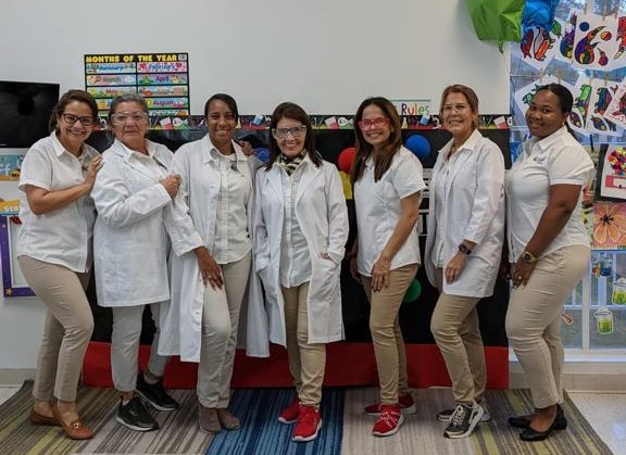 Forever Kids Academy Staff standing together in front of a white wall.