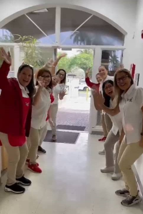 Forever Kids Academy greeting teachers standing a both sides do the entrance hall of the facility, welcoming pre schoolers and toddlers for the day care program.